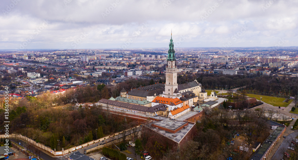 Naklejka premium Aerial view of active Catholic Jasna Gora Monastery in Czestochowa on background with modern cityscape in spring, Poland