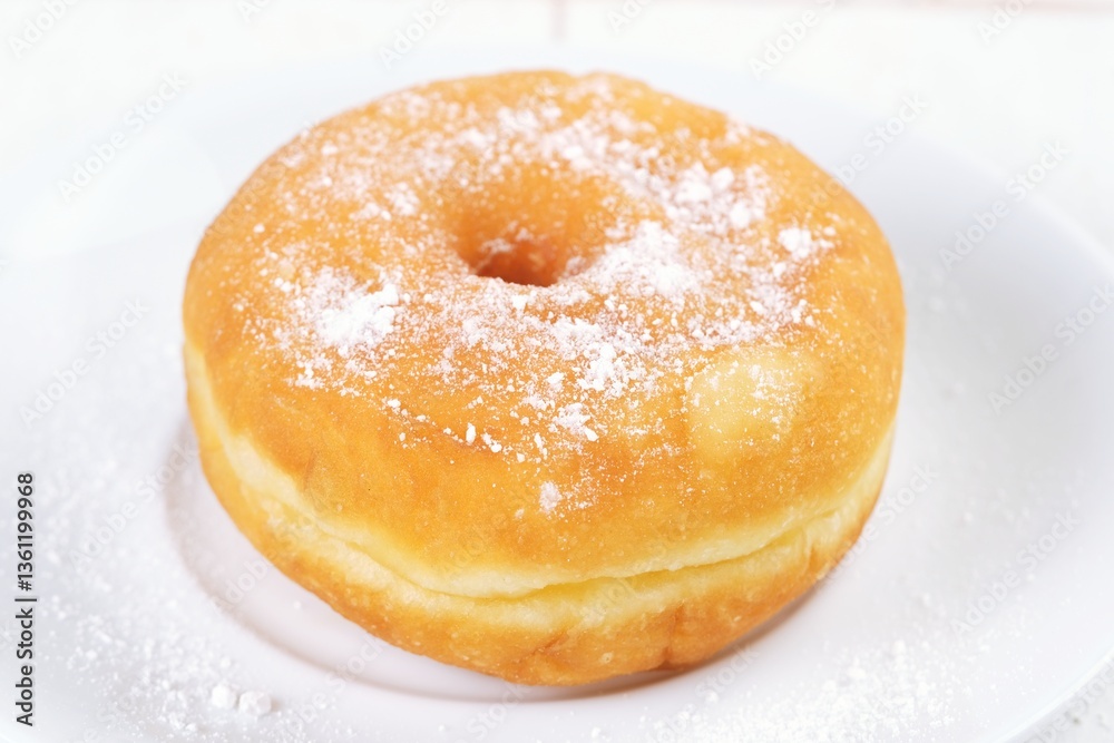 Classic golden-brown donut topped with powdered sugar, served on a clean white plate. Perfect sweet treat for breakfast or dessert, soft and fluffy texture with a light sugary coating. Classic golden-brown donut topped with powdered sugar, served on a clean white plate. Perfect sweet treat for breakfast or dessert, soft and fluffy texture with a light sugary coating.