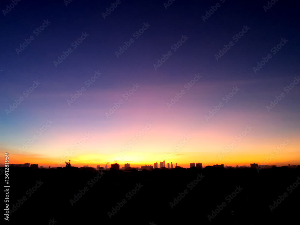 Dreamy purple sky twilight background and sunlight with copy space. silhouette of city.
