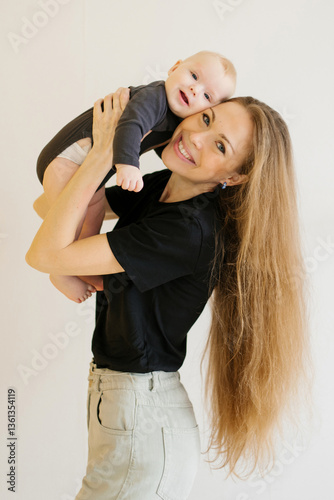Happy Mother Holding Her Smiling Baby