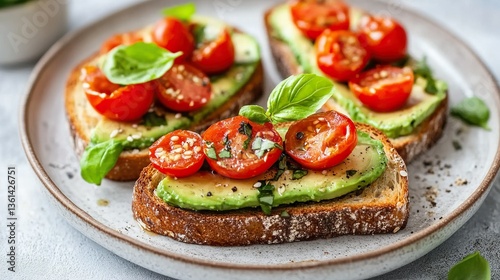 Delicious avocado toast topped with cherry tomatoes and herbs on a plate