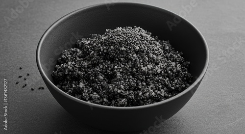 Black Sesame Seeds in Bowl Isolated on Minimalist Gray Background photo