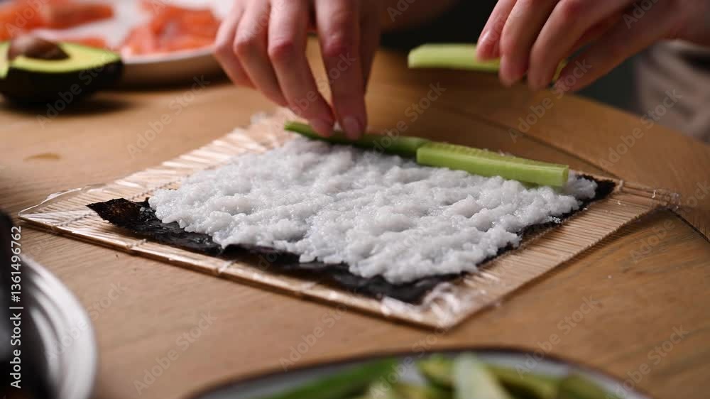 Making sushi at home with salmon, cucumber and avocado Making sushi at home with salmon, cucumber and avocado