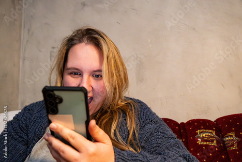 Excitement fills the room as a mother discovers something unexpected on her phone