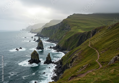 Rugged cliffs and ocean waves with a misty sky and rocky shore.