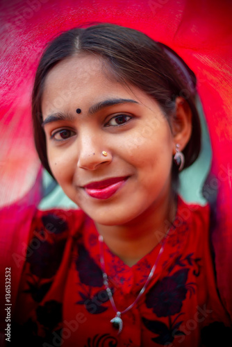 A portrait of a beautiful young Asian woman against a red veiled background. Fashion model portrait.
