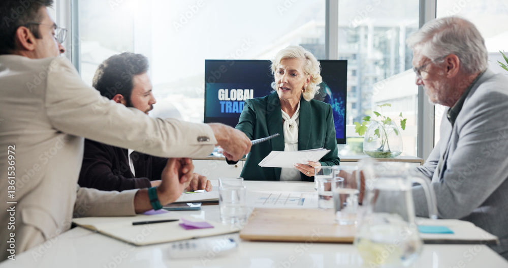 Obraz premium Discussion, serious and group with documents in boardroom, collaboration or negotiation for global trade. Teamwork, colleagues and people with paperwork for international investment, trader and ideas