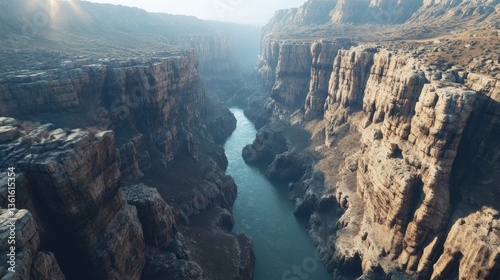 Scenic aerial view of majestic canyon with river flowing through rocky cliffs at dawn