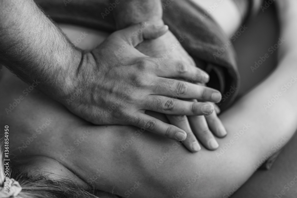 Physical therapist performs a deep tissue massage on a patients shoulder to relieve muscle tension and improve mobility in a therapeutic setting Physical therapist performs a deep tissue massage on a patients shoulder to relieve muscle tension and improve mobility in a therapeutic setting