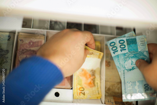 Businessman counting and exchanging money - Brazilian Real - Reais.