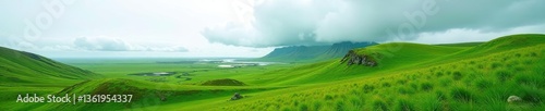 Green foliage covering the rolling landscape with a dramatic cloud on the horizon in Southern Iceland; Skaftarhreppur, Southern Region, Iceland,  travel,  landscape