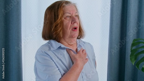 Senior woman feeling unwell, heart attack symptoms. 