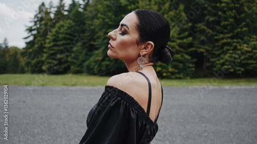 dark glamour model in her 30s, demonic brooding and deep contemplation, witch performing witchcraft, dancer posing in a scenic outdoor setting
