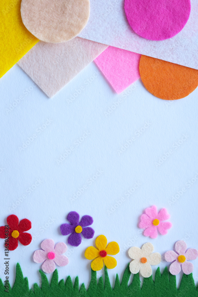 Obraz premium Handmade felt spring meadow, colorful textile flowers, DIY floral craft, green grass, soft petals, home decoration, creative sewing project, pastel background, nature-inspired design