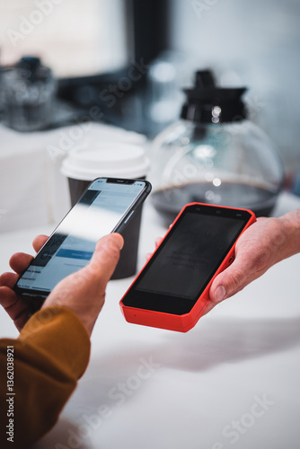 Close-up: a customer makes a purchase in a coffee shop, pays with a QR code. Scans the QR code with a smartphone in the bank's application.