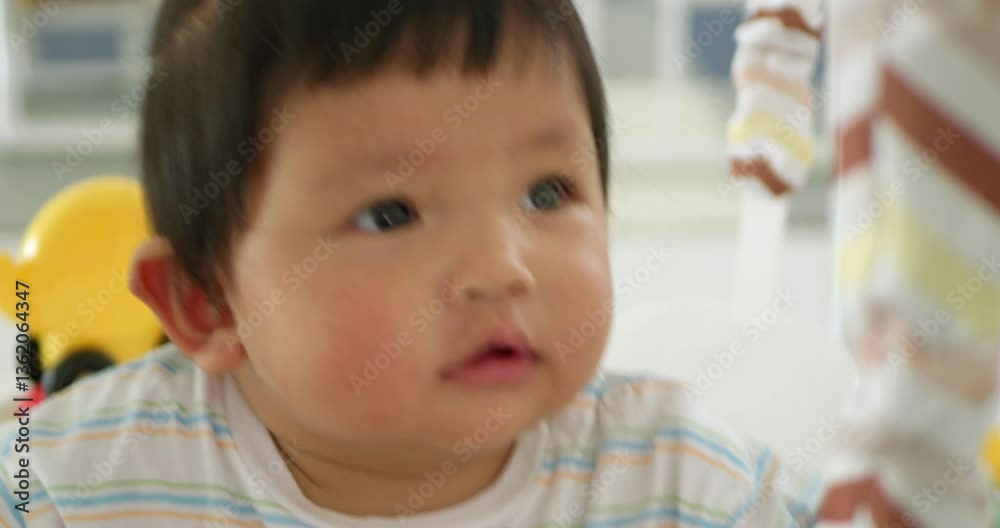 A heartwarming scene of a baby girl receiving loving care during playtime at home. A heartwarming scene of a baby girl receiving loving care during playtime at home.