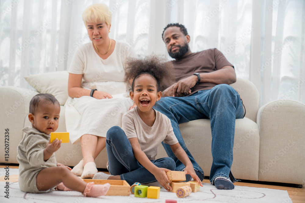 Family enjoys quality time together in a cozy living room while children play with colorful toys Family enjoys quality time together in a cozy living room while children play with colorful toys