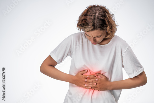 Frustrated woman bending forward and gripping her stomach with a painful look, red glow indicating strong abdominal pain. Ideal for digestive health, period cramps, or gastrointestinal topics.