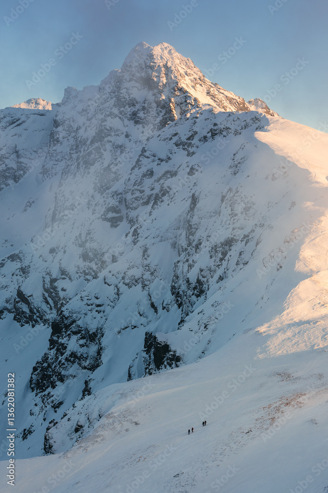 Snow-covered peaks of the Tatra Mountains with Kasprowy Wierch in winter. Stunning alpine scenery, perfect for skiing, hiking, and photography. Cold, crisp air and breathtaking views