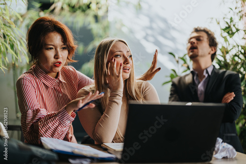 Tableau sur toile A group of business people expressing frustration and stress during a team meeting