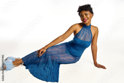Elegant african american woman showcasing chic fashion in a stunning blue lace dress