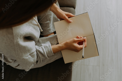 Thoughtful moments of creativity at home with a blank notebook and pen photo