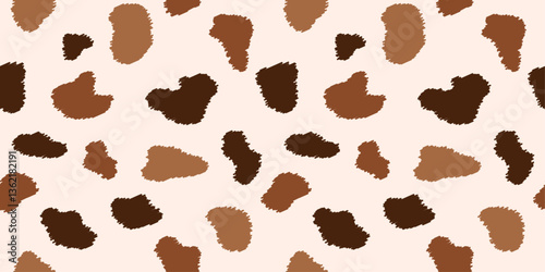 A seamless cow print pattern with irregular brown and beige patches. Cowhide textured background for textile, wrapping paper, fabric, wallpaper, cover.