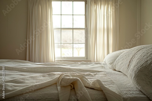 Cozy bedroom with a neatly made bed, soft natural light streaming through window curtains, serene view outside