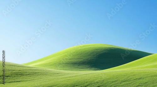 Lush green hills under a vibrant blue sky. Gentle rolling hills of vibrant green grass stretch into the distance, against a clear cerulean sky