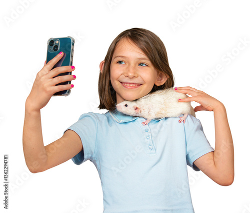 Child holding white pet rat on shoulder and taking selfie on mobile phone, isolated on white background. A cute young girl with a pet rat.