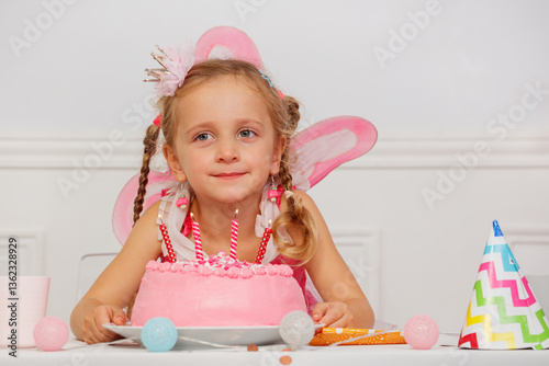 Obraz na płótnie Little girl beams at birthday party with pink cake and candles w salonie