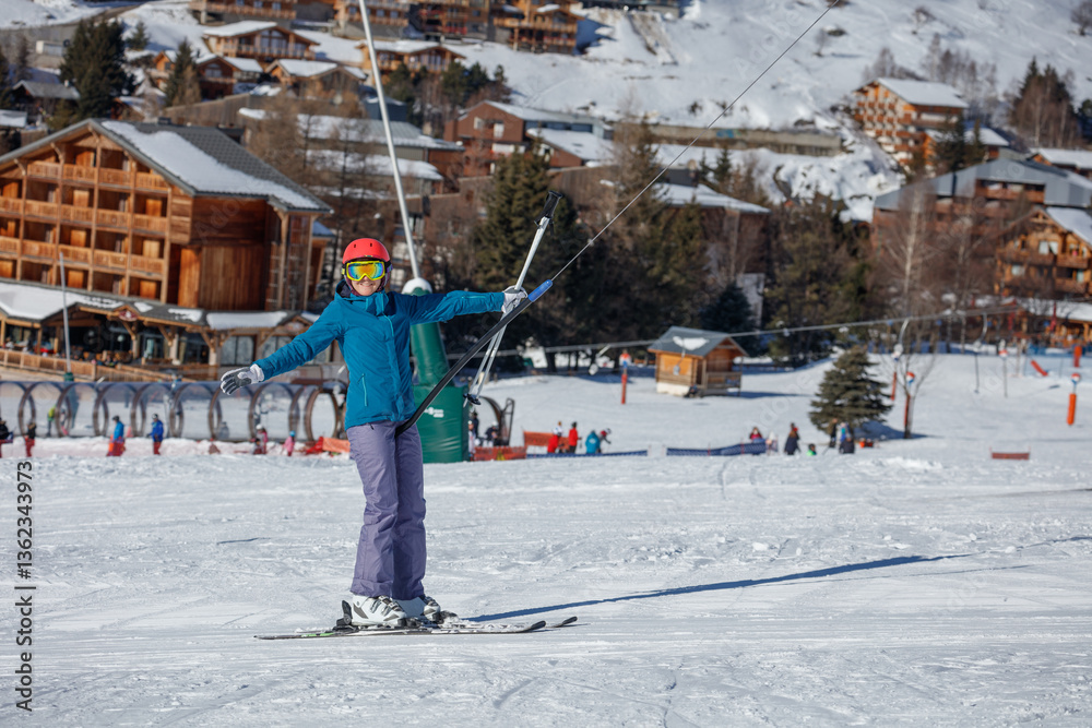 Skier woman on tow lift enjoying a snowy day at mountain resort