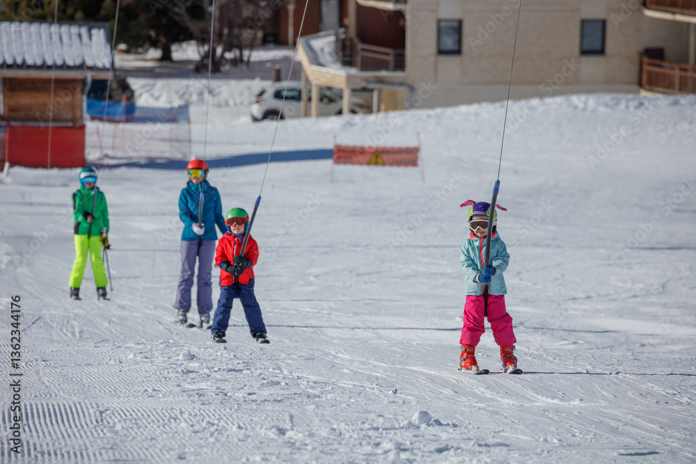 Ski lift carries skiers up the snowy winter mountain on resort