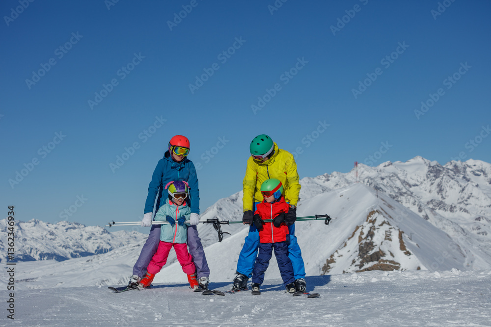 Family enjoys skiing together in a beautiful mountain setting