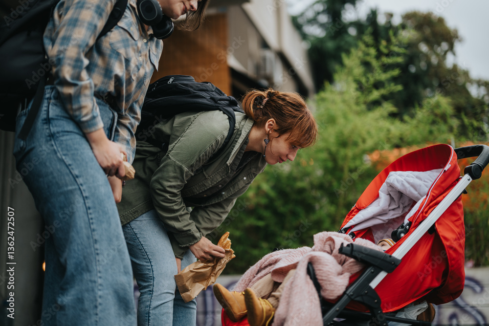 Two women engaged in a cheerful interaction with a baby in a red stroller, enjoying a pleasant outdoor setting. The scene captures friendship, care, and joy in a relaxed atmosphere. Two women engaged in a cheerful interaction with a baby in a red stroller, enjoying a pleasant outdoor setting. The scene captures friendship, care, and joy in a relaxed atmosphere.