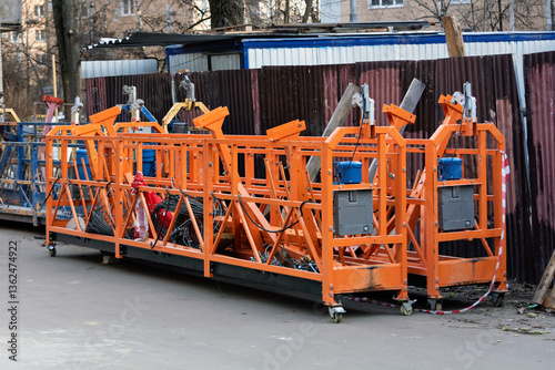 Bild auf Leinwand Multiple suspended scaffold platforms stand on site, showcasing industrial construction equipment used for facade work and repairs