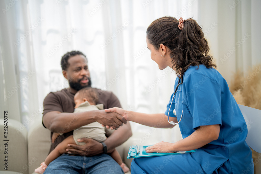 Obraz premium Healthcare professional interacts with father holding baby in a consultation setting during daytime