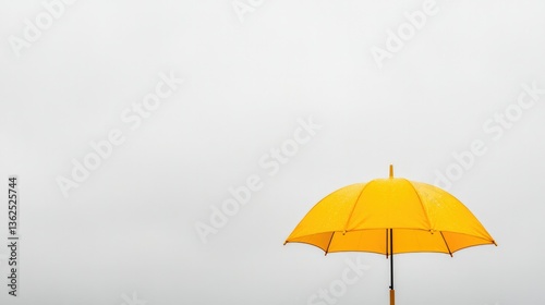 Wallpaper Mural Bright yellow umbrella standing out against a rainy grey sky, bold and uplifting Torontodigital.ca
