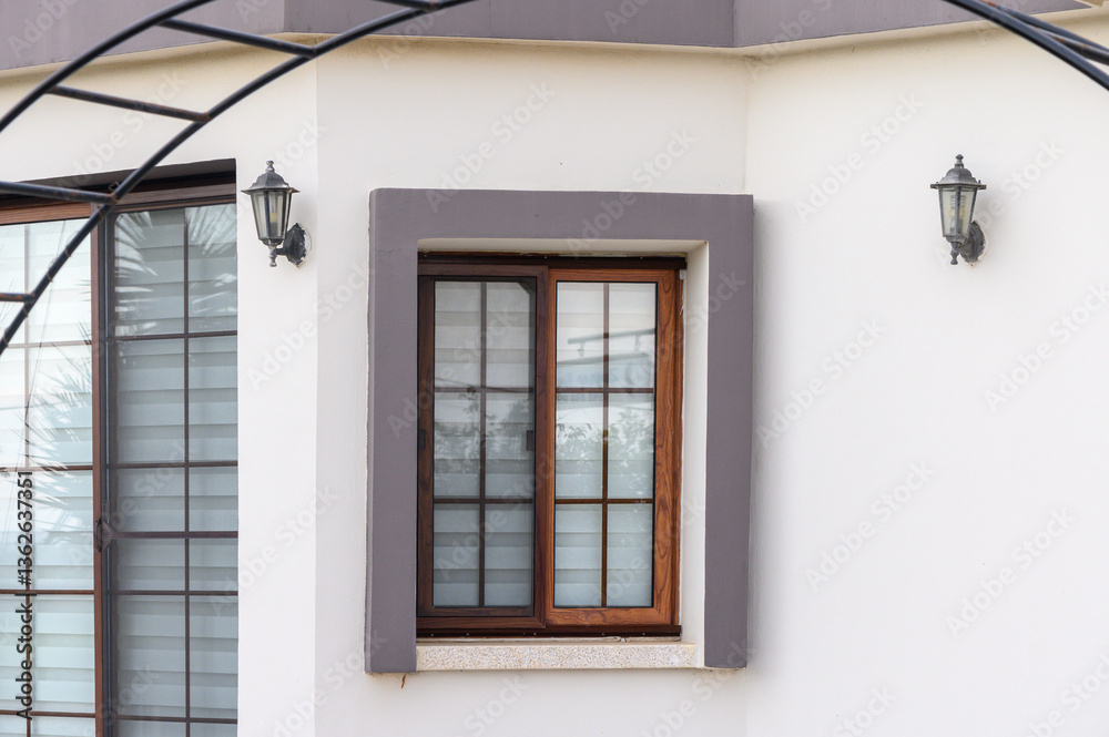 Fototapeta premium Charming wooden window framed by elegant architecture in a serene setting reflects peaceful outdoor ambiance