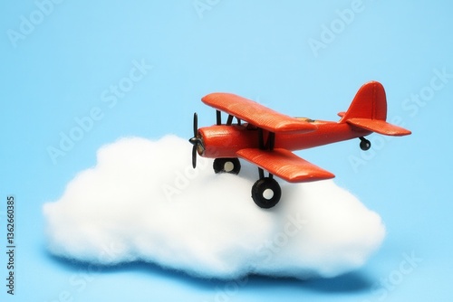 Colorful Toy Airplane Flying Above White Cloud on Blue Background