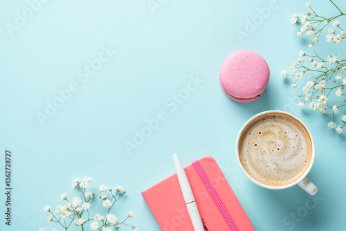 Cup of coffee, macaroon and flower on blue background.