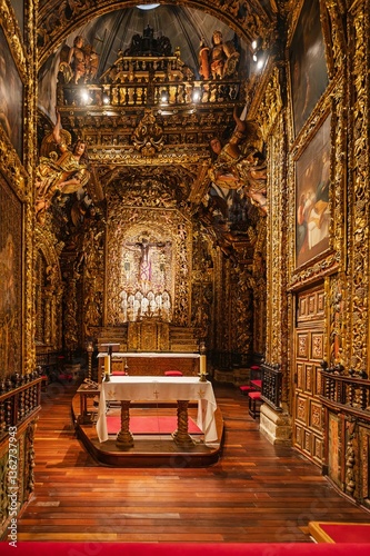 Golden altar inside the orense cathedral showing ornate details and wooden floor