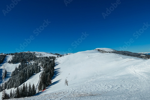 Obraz na płótnie Snow-covered peaks dominate serene landscape of Wölkerkogel, Styria, Austria. Pristine alpine winter beauty and tranquility in remote Austrian Alps. Distant mountain ridges and hills in Lavanttal Alps w salonie