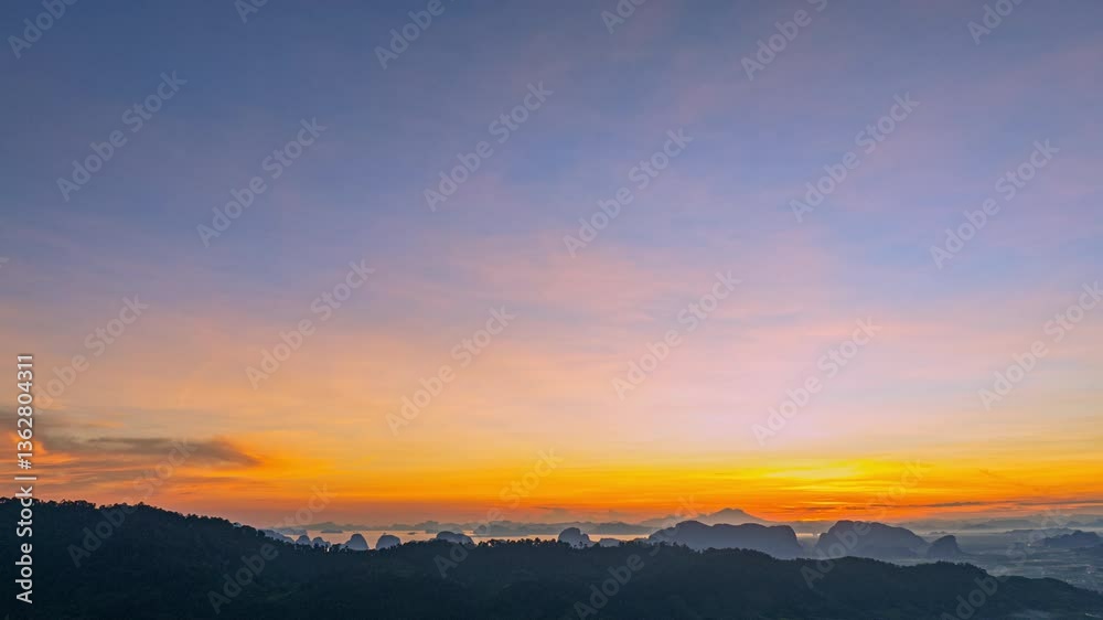 Aerial hyper lapse view of serene sunset casts a golden glow over rolling hills and distant mountain peaks, creating a peaceful and atmospheric landscape with layers of mist and soft light. Aerial hyper lapse view of serene sunset casts a golden glow over rolling hills and distant mountain peaks, creating a peaceful and atmospheric landscape with layers of mist and soft light.