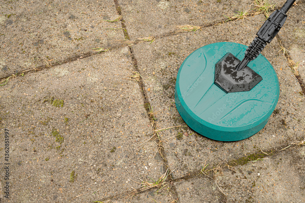 a round high-pressure washer on old dirty concrete slabs