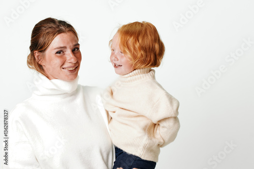Mother and daughter outfit coordination elegant white turtleneck sweater and blue jeans fashion style