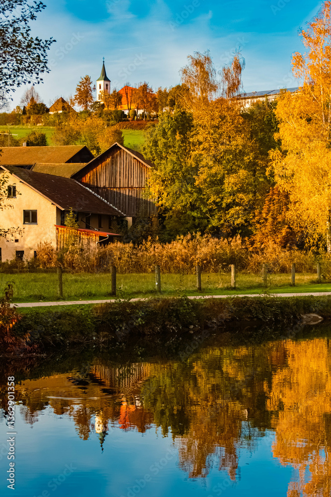 Autumn or indian summer view with reflections in a lake at Arrach, Cham, Bavarian Forest, Bavaria, Germany Autumn or indian summer view with reflections in a lake at Arrach, Cham, Bavarian Forest, Bavaria, Germany