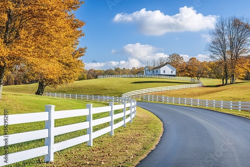 Countryside Landscape with White Fence, Road, Rolling Green Hills and Autumn Trees