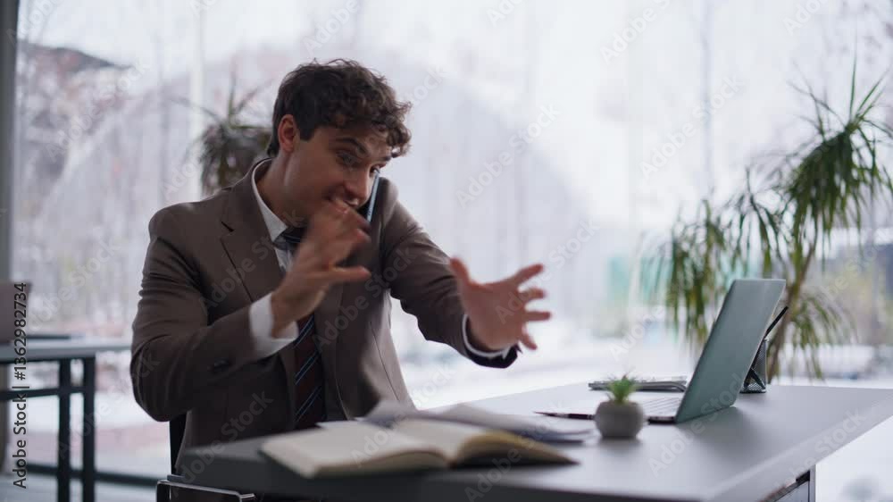 Multitasking businessman talking smartphone reading documents in office closeup