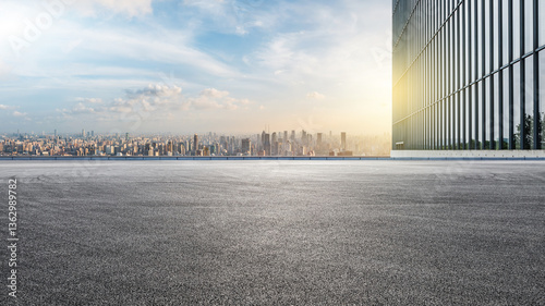 Asphalt road square and city skyline with modern buildings scenery at night. car advertising background.